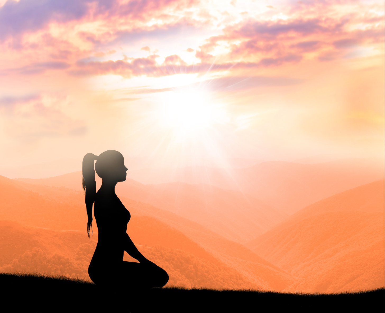 Meditation. Silhouette of woman in mountains.