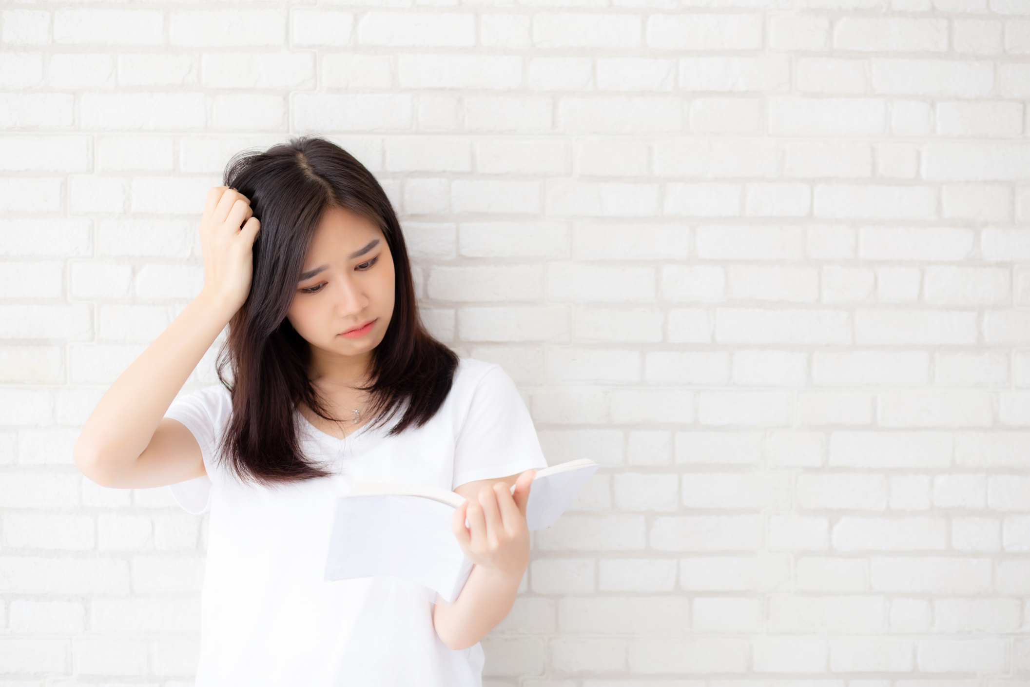 Young Woman Stressfully Reading Book 